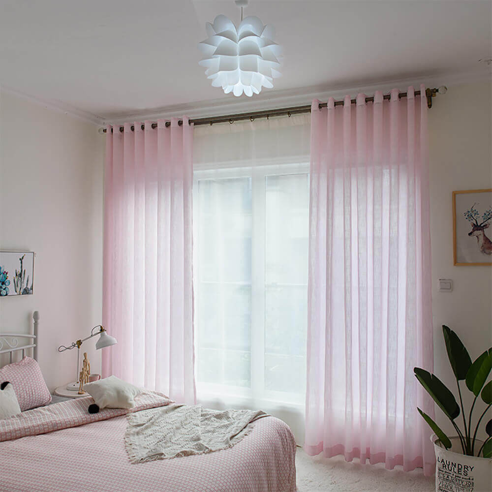 Modern sheer curtain panels filtering natural light while maintaining bedroom privacy